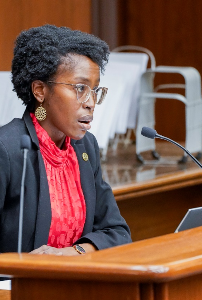 Esther talking into a microphone in the house